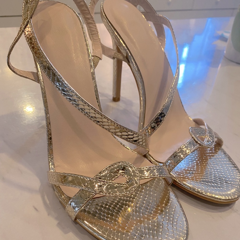 Brand new gold high heel sandals .